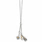 Brighton charm necklace with two-tone starburst, crystal drop, and nativity scene pendants on a white background