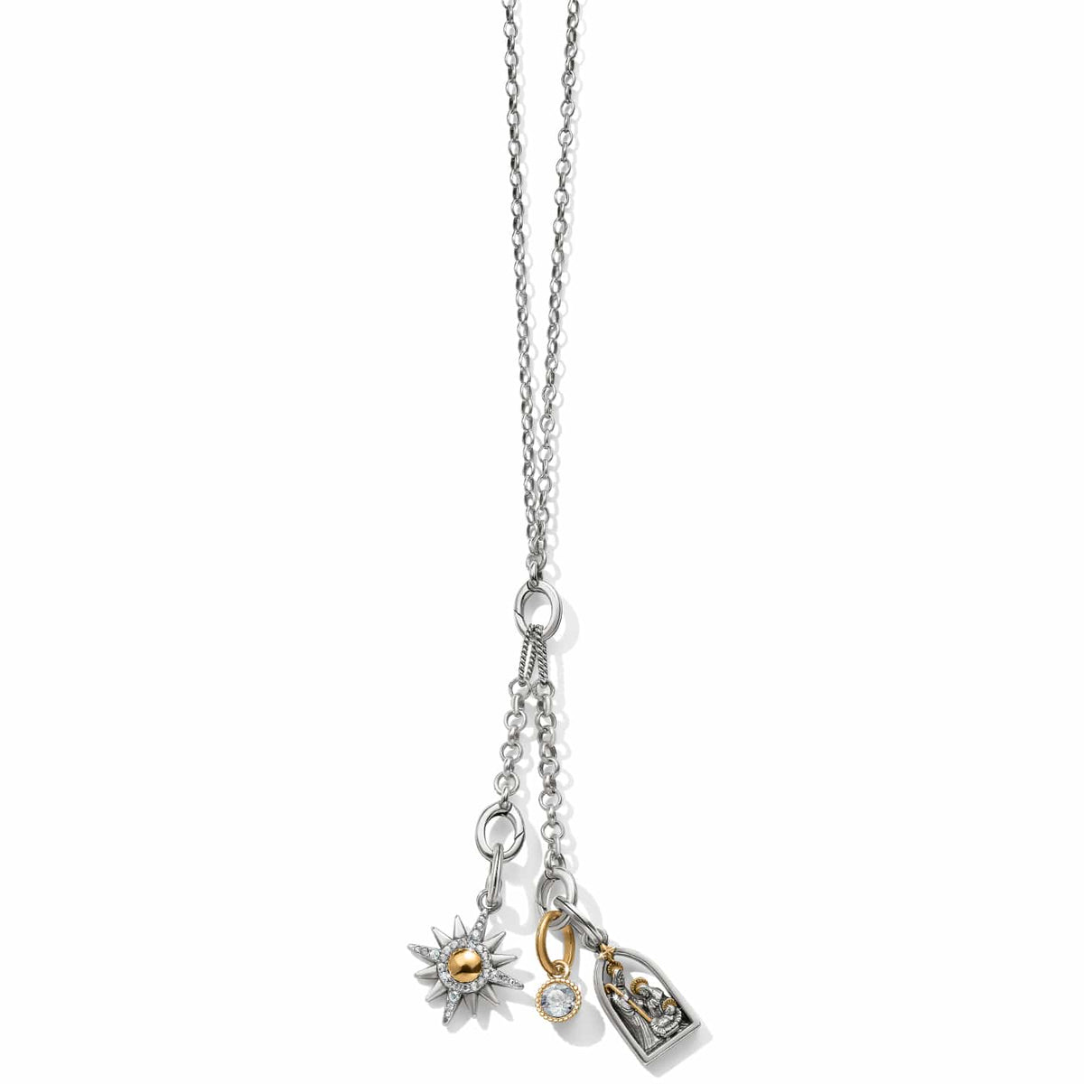 Brighton charm necklace with two-tone starburst, crystal drop, and nativity scene pendants on a white background