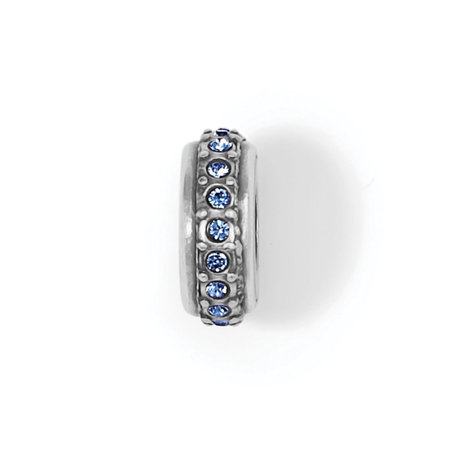 Brighton spacer charm with silver-plated finish and row of blue crystals around the band on a white background