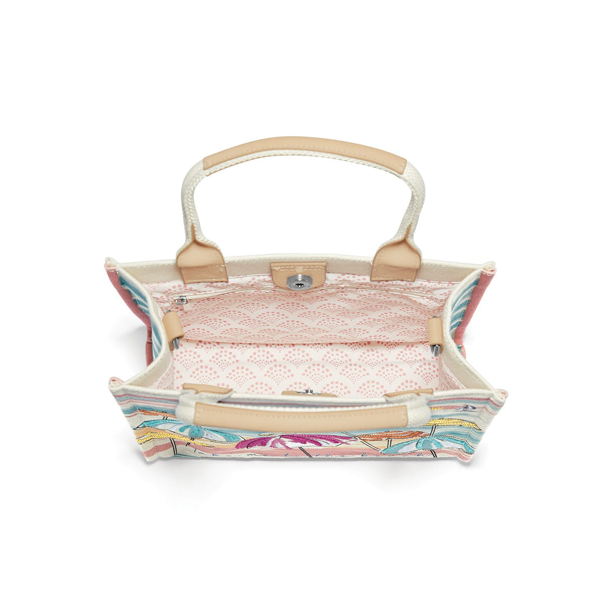 Brighton handbag interior view showing pink patterned lining, zip pocket, and tan leather handle accents on a white background