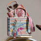 Brighton canvas tote with embroidered beach umbrella print, styled with sunglasses and other accessories on neutral background