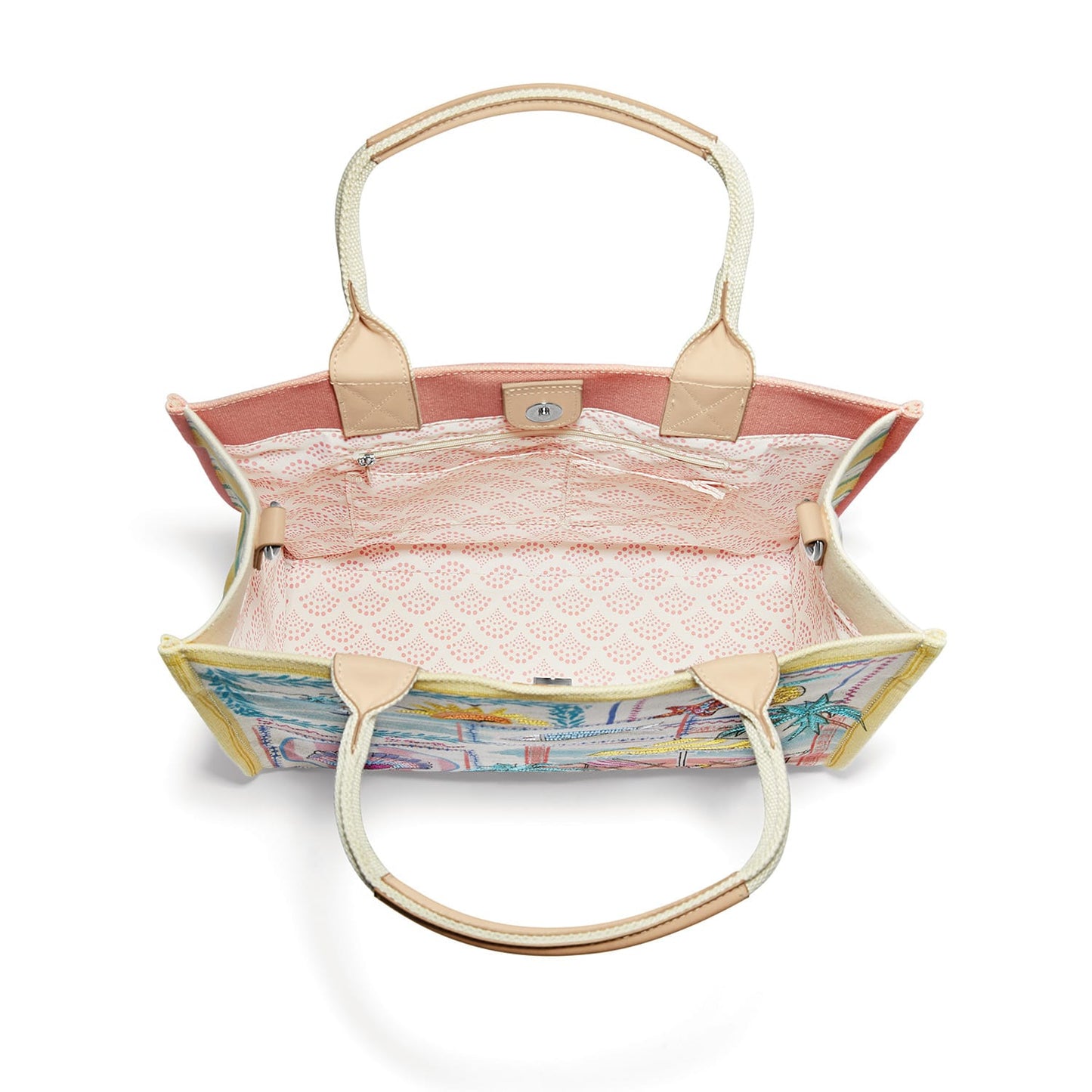 Brighton handbag interior view showing pink patterned lining, zip pocket, and canvas handles on a white background