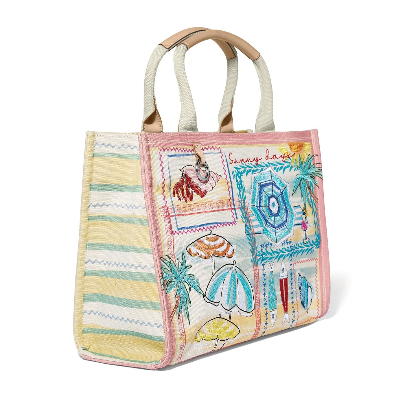 Brighton canvas tote handbag with embroidered beach umbrella print, striped side panels, and tan handles on a white background