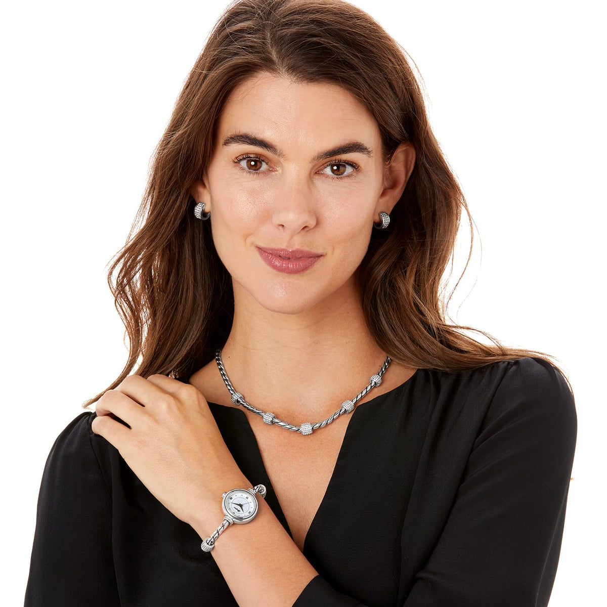 Model wearing a Brighton silver-plated cable necklace with crystal stations and coordinating Brighton accessories
