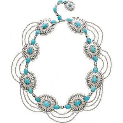 Brighton silver-tone necklace with dyed turquoise howlite stones in concho medallions and draped chains on a white background