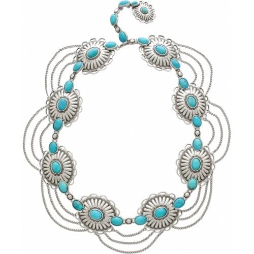 Brighton silver-tone necklace with dyed turquoise howlite stones in concho medallions and draped chains on a white background