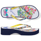Brighton rubber flip-flop sandals with floral print, butterfly footbed, yellow straps, and navy platform on a white background