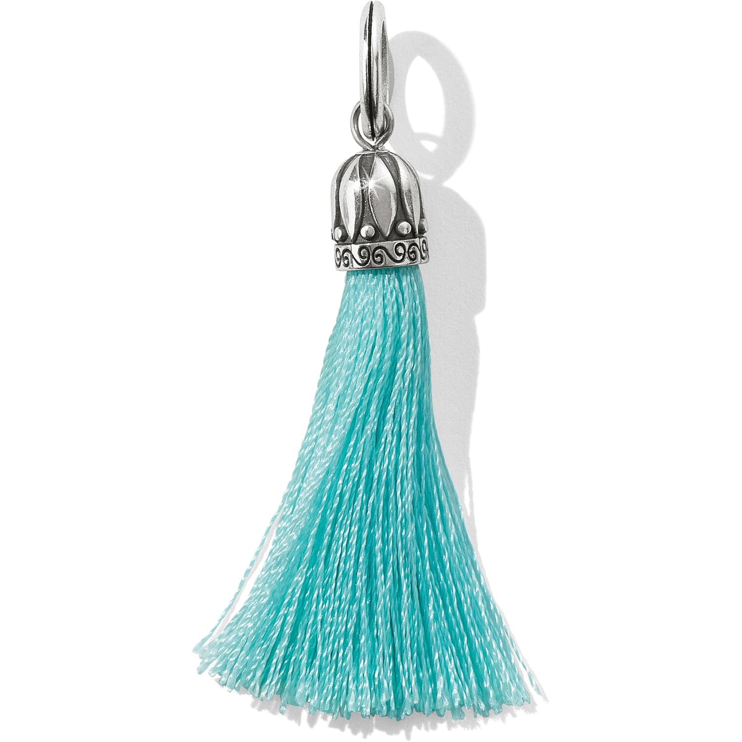 Brighton tassel charm with turquoise fringe and silver-plated decorative cap with scroll detailing on a white background