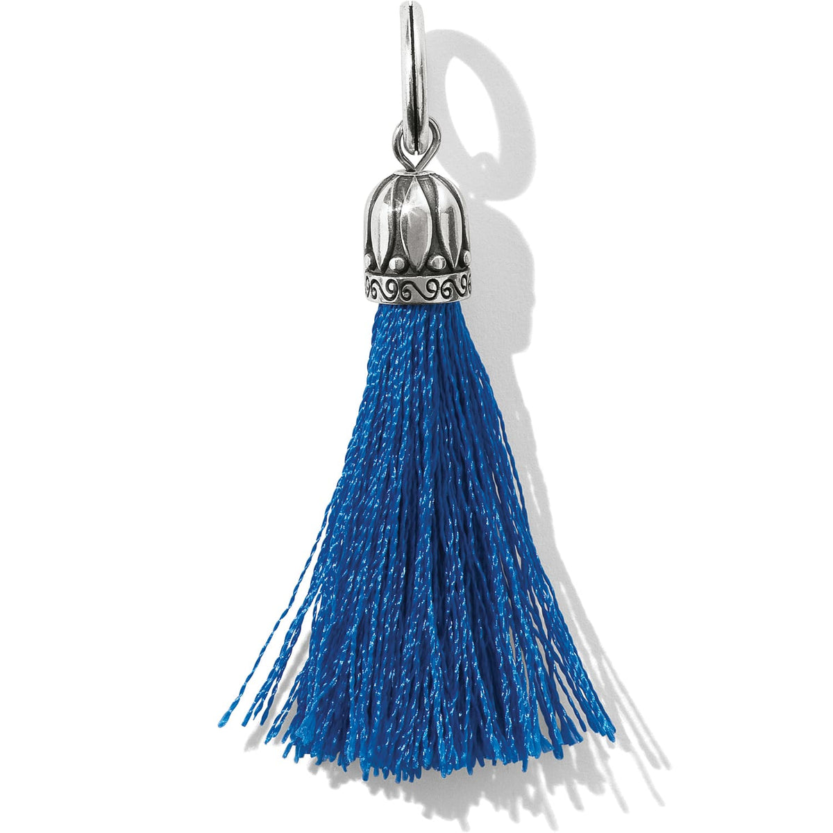 Brighton tassel charm with blue fringe and ornate silver-plated cap featuring scroll detailing on a white background