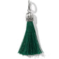 Brighton tassel charm with green threads and silver-plated decorative cap with scrollwork detail on a white background