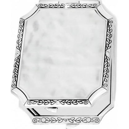 Brighton silver-tone compact mirror with engraved leaf border, crystal accents, and hammered center panel on a white background