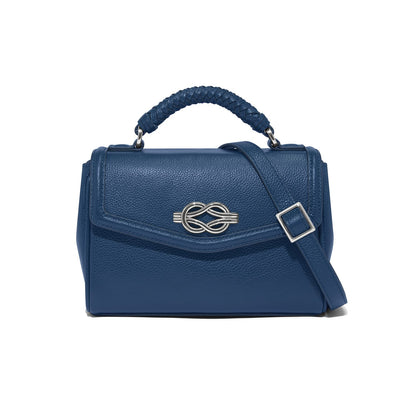 Brighton blue leather handbag with braided top handle, silver-tone knot clasp, and adjustable crossbody strap on a white background