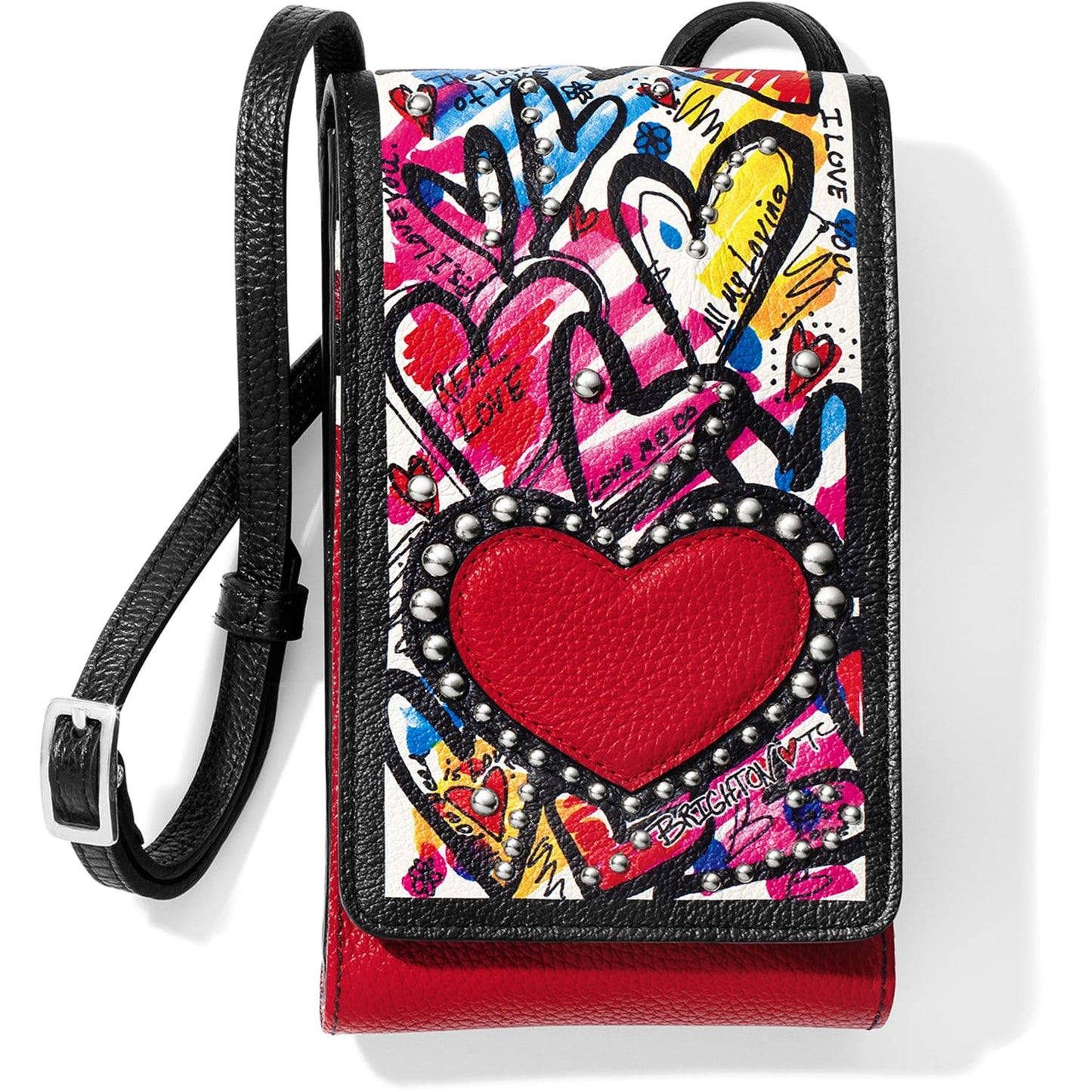 Brighton crossbody handbag with graffiti heart print, red leather heart appliqué, studs, and black strap on a white background