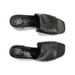 Brighton black leather slide sandals with swirl stitching, perforated detail, and medallion accent on a white background