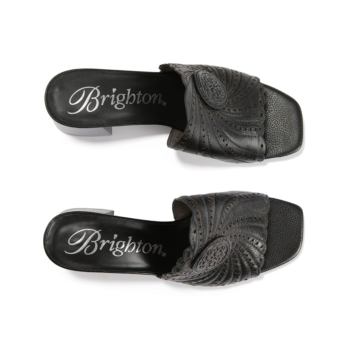 Brighton black leather slide sandals with swirl stitching, perforated detail, and medallion accent on a white background