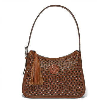 Brighton shoulder handbag in brown leather with diamond cutouts, stud accents, medallion emblem, and tassel on a white background