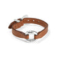 Brighton brown leather bracelet with silver-plated hammered ring centerpiece and buckle closure on a white background