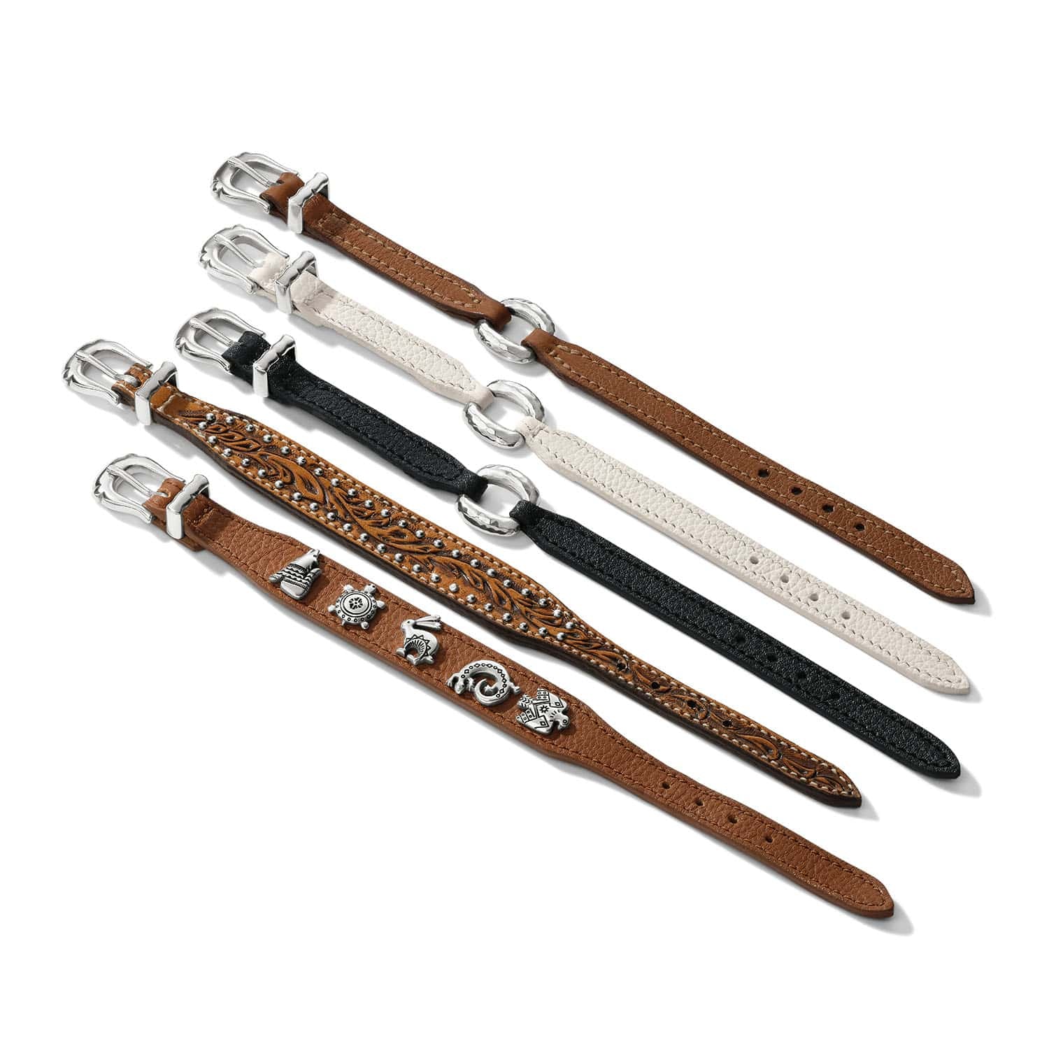 Brighton leather straps in brown, black, and white with silver-plated buckles and decorative charms on a white background