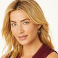 Model wearing Brighton drop earrings with silver-plated bow charm and red, green, and amber crystal cube beads