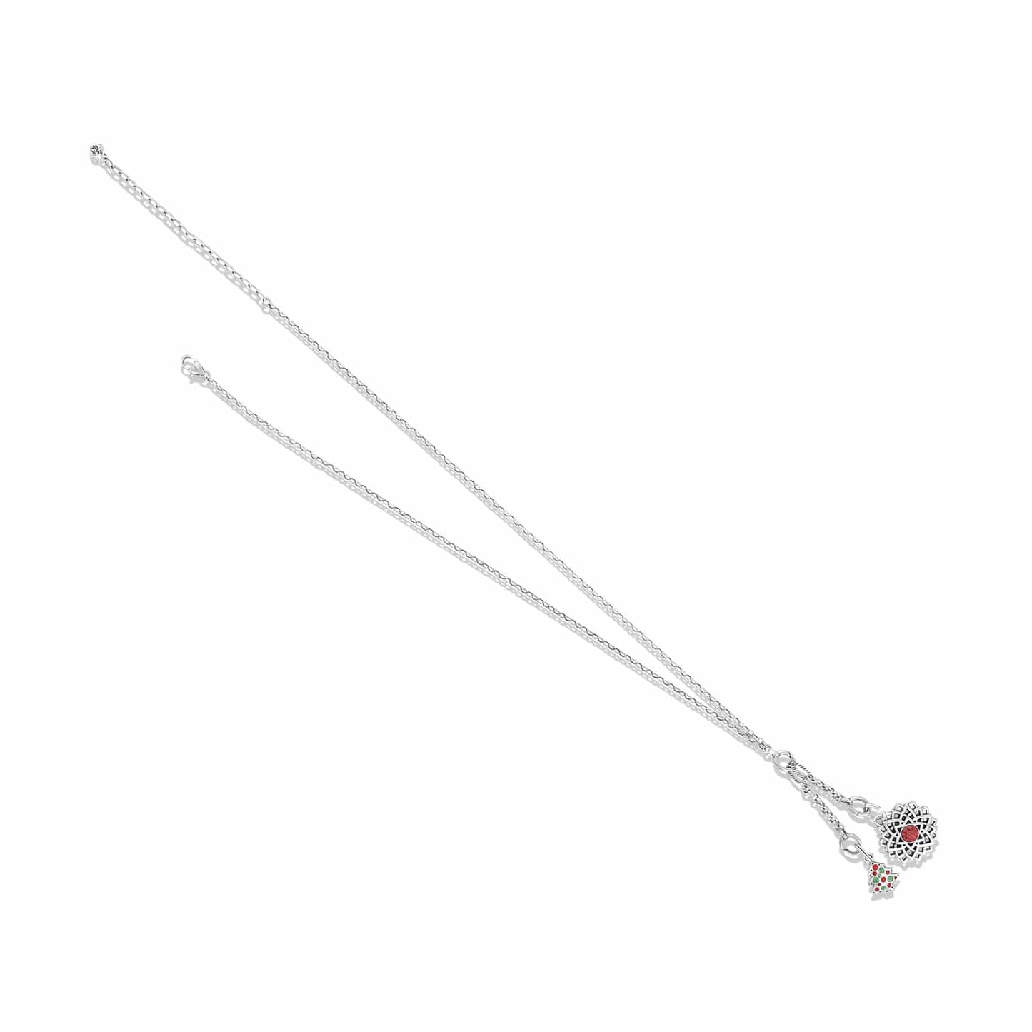 Brighton charm necklace with silver-tone chain, heart charm with red crystal, and Christmas tree charm on a white background