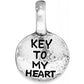 Brighton round charm with silver-plated finish and engraved Key To My Heart text on a white background