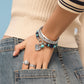 Model wearing a Brighton beaded bracelet with turquoise and lapis stones and coordinating Brighton accessories