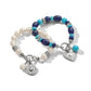 Brighton beaded bracelets with freshwater pearls, lapis, turquoise, and silver-plated heart and medallion charms on a white background