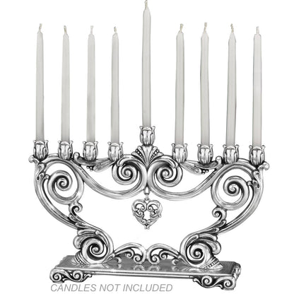 Brighton silver-plated menorah with ornate scrollwork, tulip candle holders, and hanging heart pendant on a white background