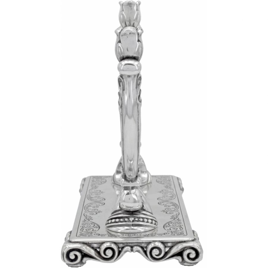 Brighton silver-plated candlestick holder with ornate scroll base and decorative engraved square platform on a white background
