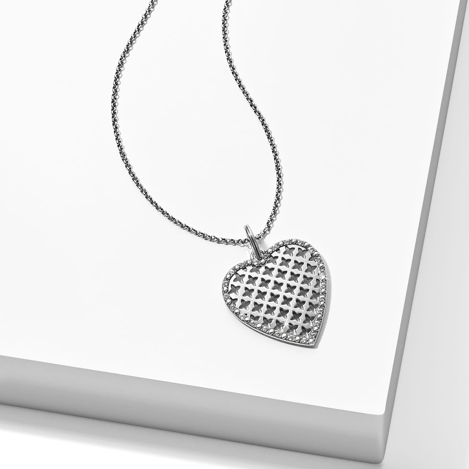 Brighton heart pendant necklace with silver-tone lattice design and crystal-edged border on a white background