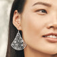 Model wearing a Brighton brushed silver-plated drop earring with fan-shaped floral cutout design and crystal accents