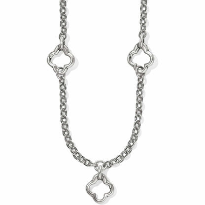 Brighton necklace with silver-plated textured chain and three open quatrefoil clover link stations on a white background