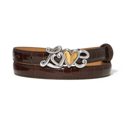 Brighton brown croc-embossed leather belt with silver-tone Love buckle featuring gold heart accent on a white background