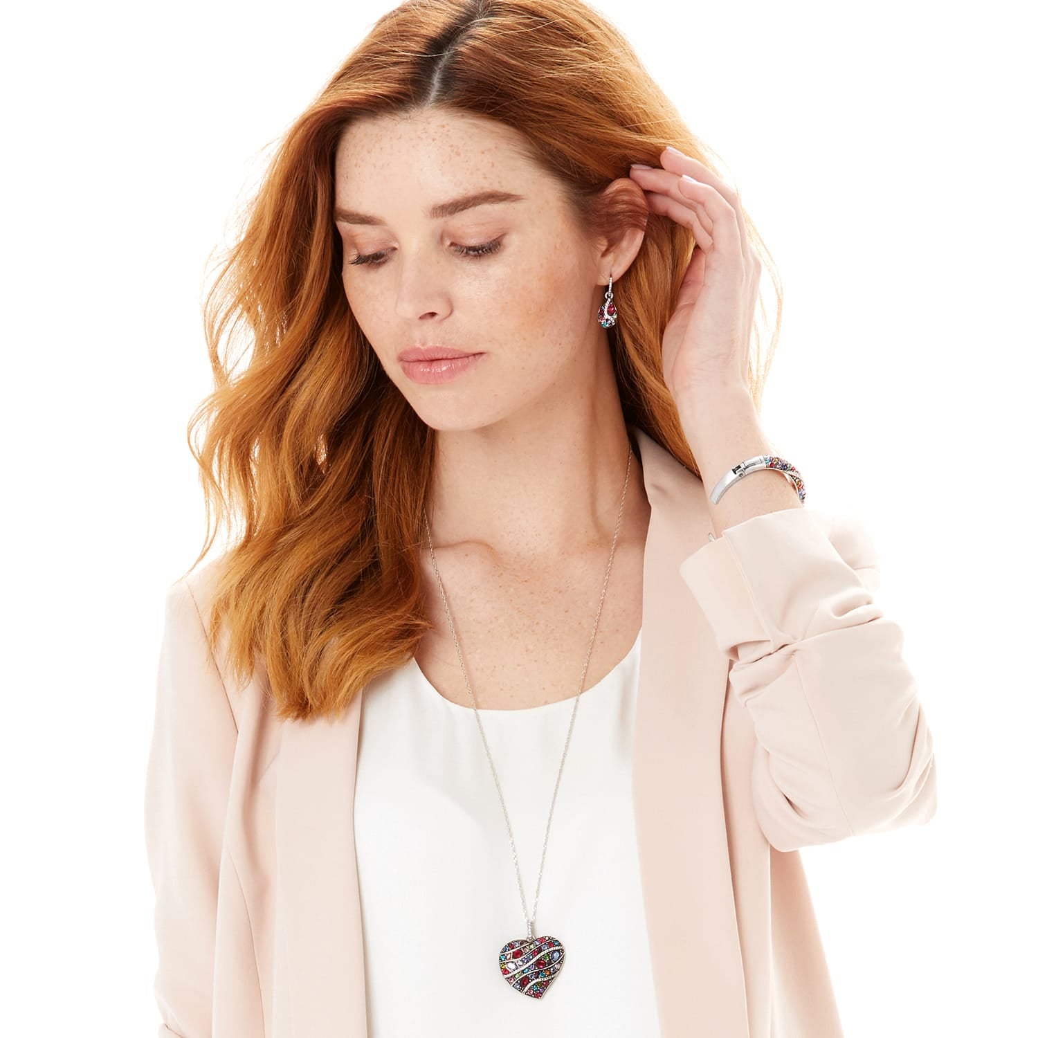 Model wearing a Brighton silver-plated heart pendant necklace with multicolored crystals and coordinating Brighton accessories