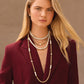 Model wearing layered Brighton Japanese baroque pearl necklaces with gold-plated chain accents and crystal stations
