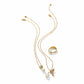 Brighton gold-plated jewelry set styled with pearl pendant necklaces, hummingbird charm, and matching pearl ring on white