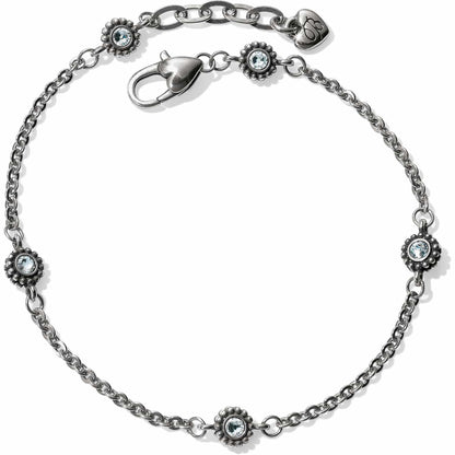 Brighton silver-plated chain bracelet with four light blue crystal floral stations and lobster clasp on a white background
