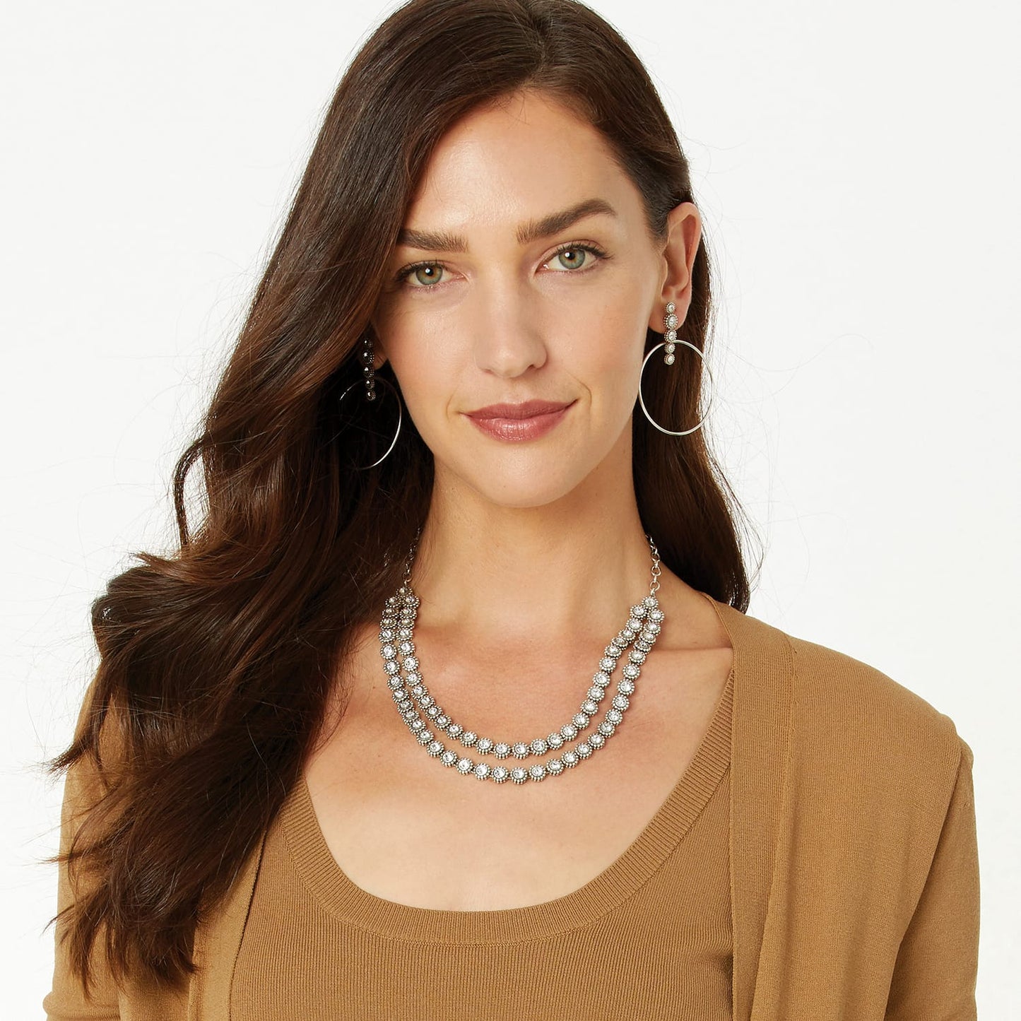 Model wearing a Brighton silver-plated layered necklace with crystals, paired with matching hoop drop earrings
