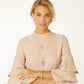 Model wearing a Brighton silver-plated layered cross pendant necklace with crystals and coordinating Brighton accessories