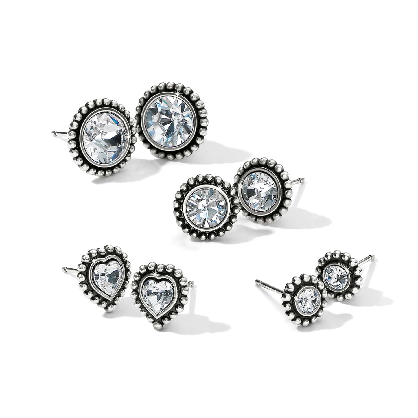 Brighton stud earrings set with round and heart-shaped crystals in silver-plated beaded frames on a white background