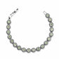 Brighton bracelet with green crystals set in beaded silver-plated links and hinged clasp on a white background