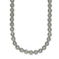 Brighton silver-plated necklace with green crystals set in beaded round links on a white background