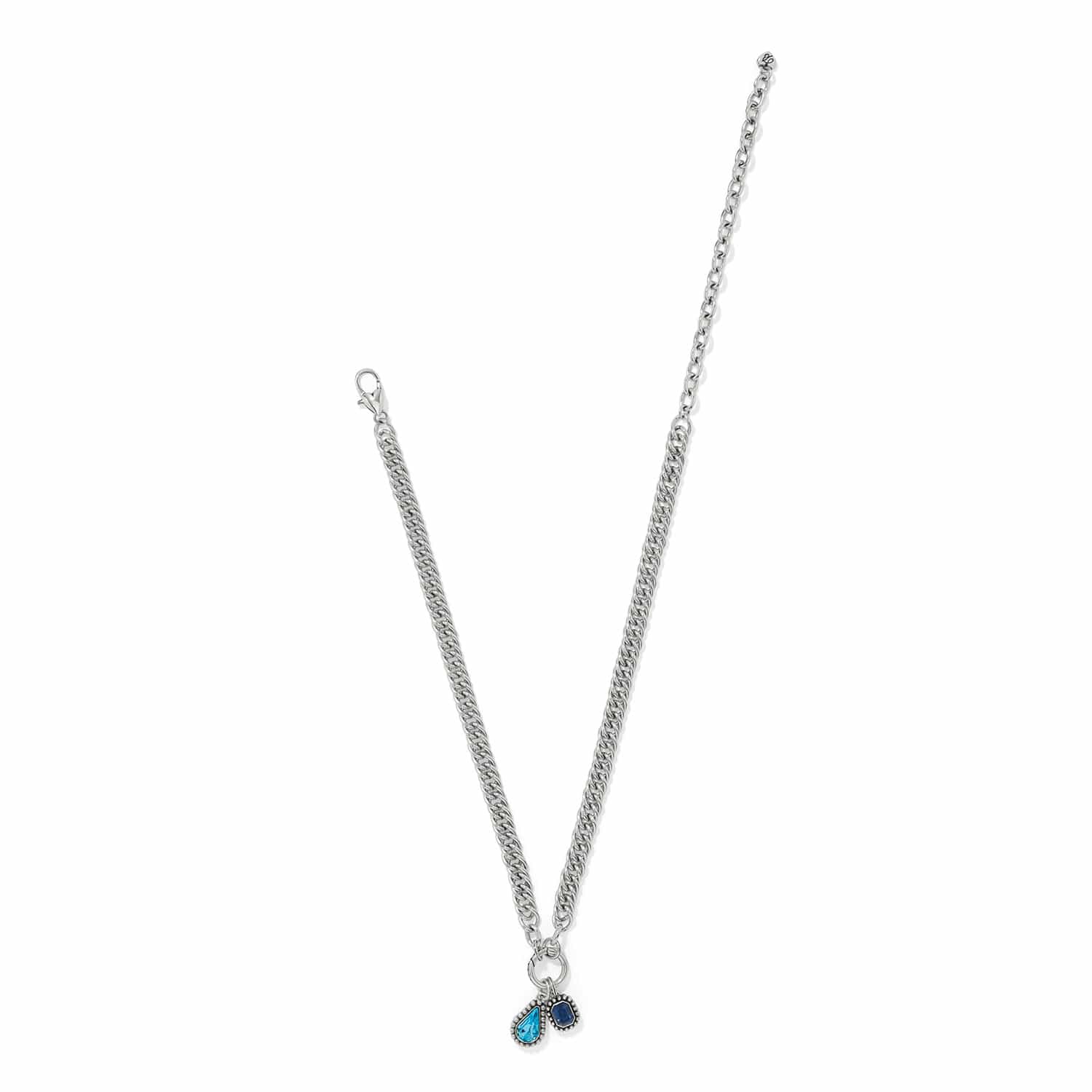 Brighton silver-plated chain necklace with blue teardrop crystal and small blue crystal charms on a white background