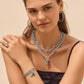 Model wearing a Brighton silver-plated layered chain necklace with blue crystal pendants and coordinating Brighton accessories