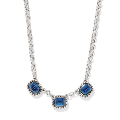 Brighton necklace with three blue emerald-cut crystals and beaded silver-plated frames on a white background