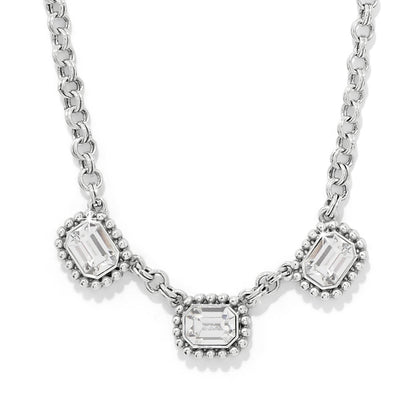 Brighton necklace with three emerald-cut crystals in silver-plated beaded frames on a rolo chain on a white background