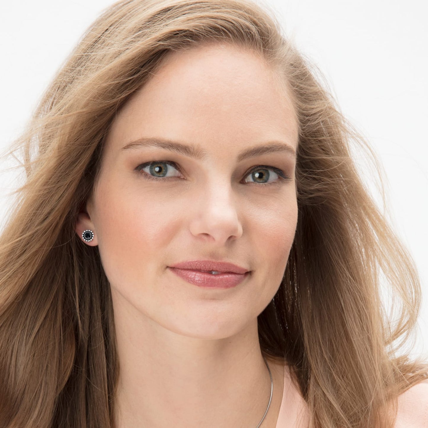 Model wearing Brighton silver-plated stud earrings with black center stones surrounded by fine quality crystals