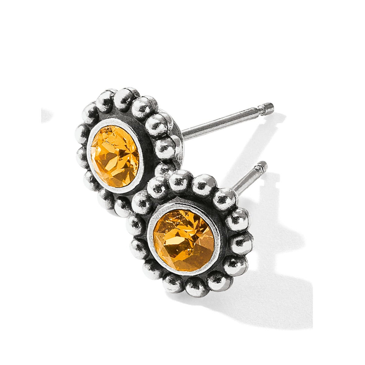 Brighton stud earrings with yellow crystal centers and silver-plated beaded borders on a white background