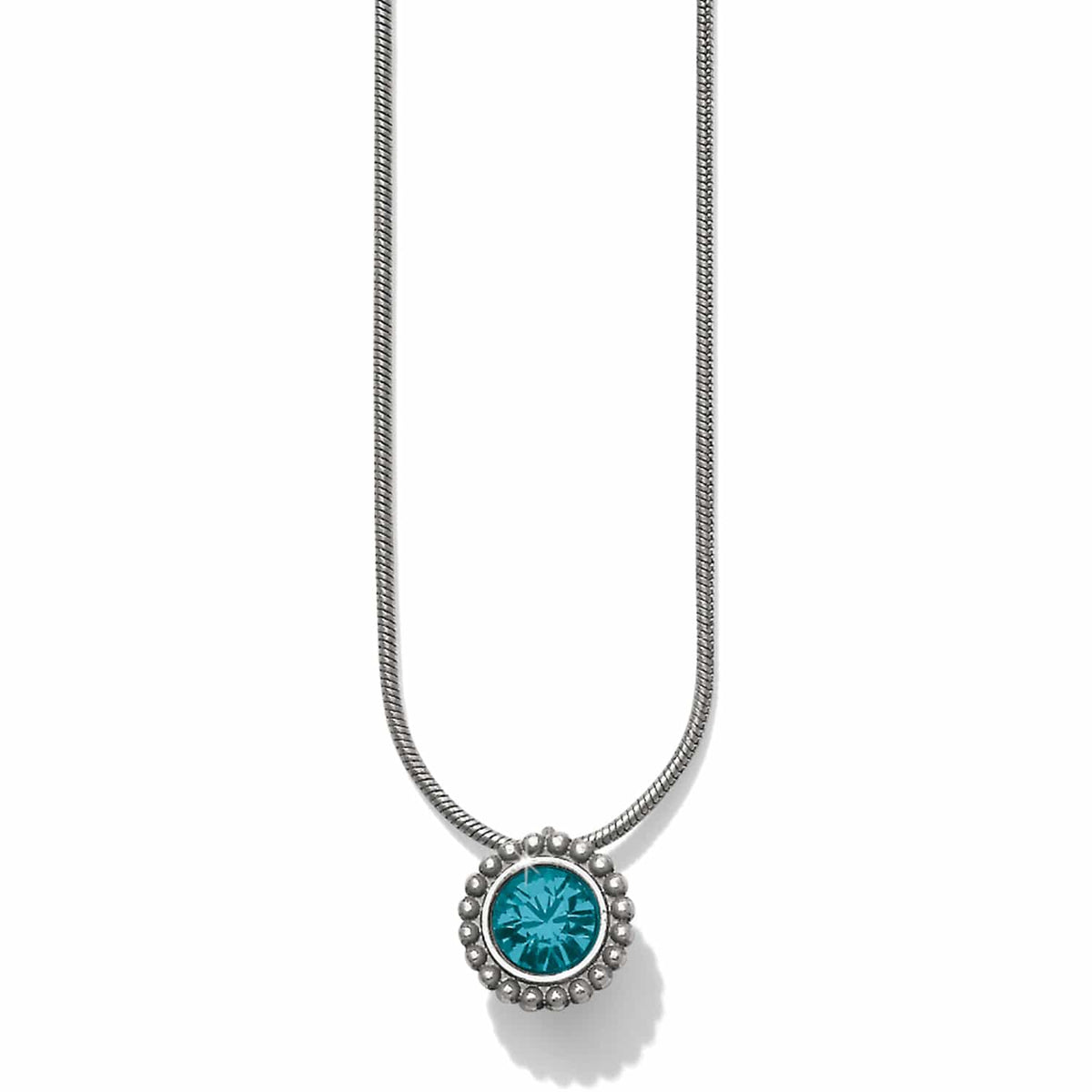 Brighton pendant necklace with round teal crystal and silver-plated beaded frame on snake chain on a white background
