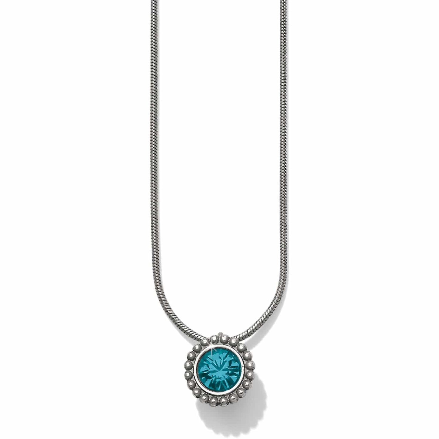 Brighton pendant necklace with round teal crystal and silver-plated beaded frame on snake chain on a white background